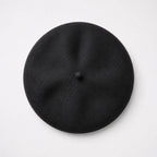 Black beret on a light gray background