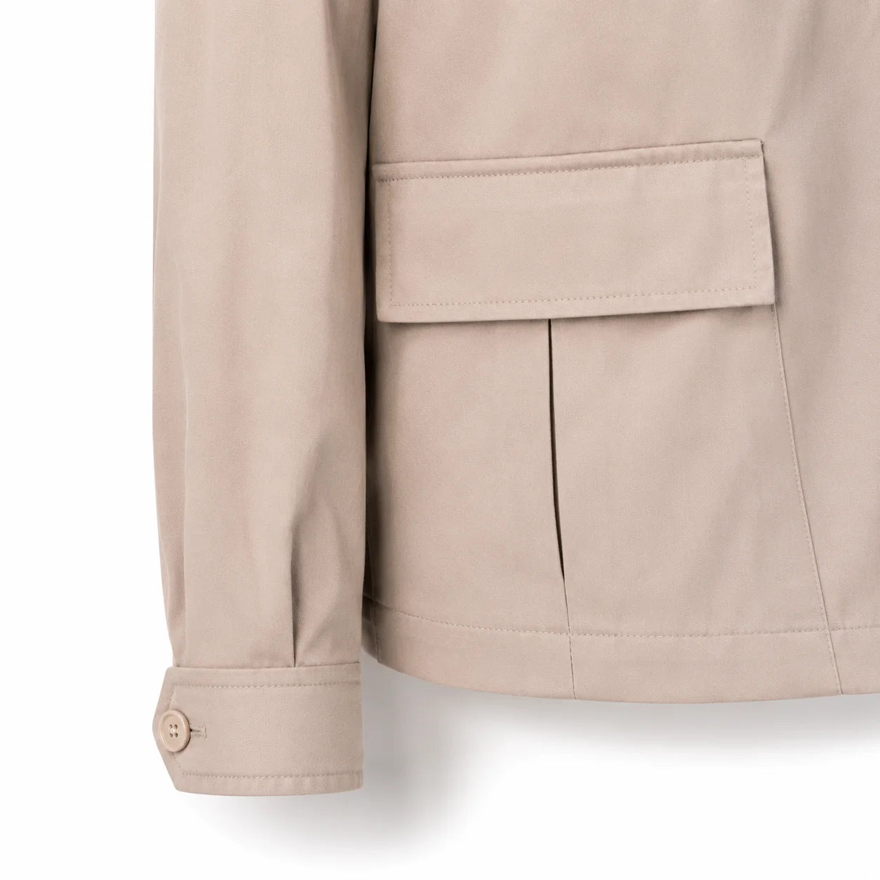 Close-up of a beige jacket sleeve and pocket, showing fabric texture and button cuff detail against a white background.