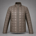 A men's quilted puffer jacket in a taupe-brown color, featuring a stand-up collar, full-length front zipper, and vertical quilting details, shown against a neutral gray background.