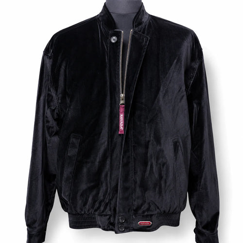 A black velvet bomber jacket displayed on a dark mannequin torso against a white background. The jacket features a silver zipper with a pink 'NAVADA' tag, side pockets, and a small metal 'NAVADA' logo badge near the bottom hem.