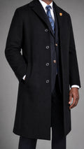 A man wearing a black Navada Clothing cashmere blend overcoat in a studio setting against a neutral grey studio backround
