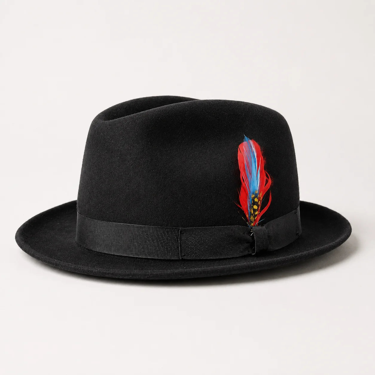 Men’s black trilby fedora hat with red and blue feather accent.